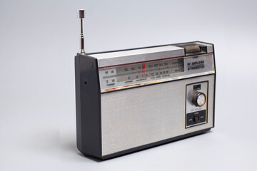 Vintage transistor radio on a gray background.