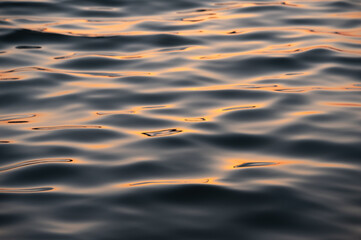 Abstract wave pattern with sunset sky reflections