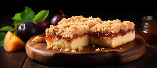  Crumbly shortbread pie with plum and apple jam on wooden board Fruit and streusel dessert With copyspace for text © 2rogan