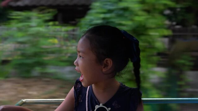 Happy small girl or passenger sitting on on sidecar for transportation.