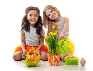 two beautiful little girls playing fluffy chicken toys on the floor isolated on white background