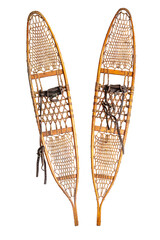 Vintage snowshoe with hardwood frame filled in with rawhide latticework isolated on a white...