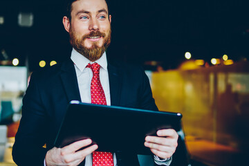 Smiling businessman using tablet in office