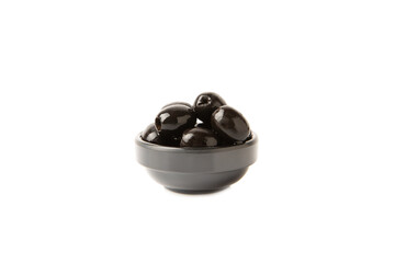 Tasty black olives isolated on white background. Olive and olive tree branches on a white table. Delicacy.
