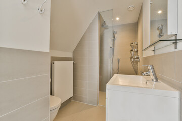 a modern bathroom with white tiles on the walls and beige tile flooring around the bathtub is visible in the mirror