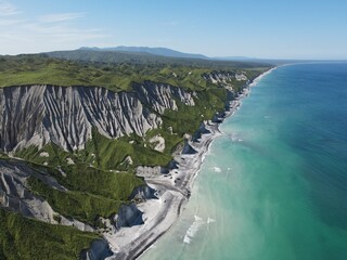 Aerial shot of white rocks and coastline of Iturup Island, Kuril islands