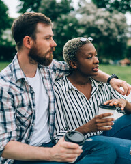 Multiracial couple taking rest in nature