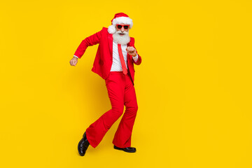 Fototapeta na wymiar Full length photo of sweet cheerful santa dressed red suit tie having fun discotheque dancing empty space isolated yellow color background