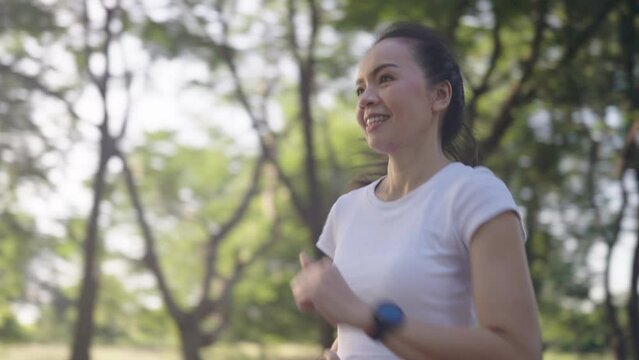 4k resolution slow motion Asian female woman doing workout stretching, jogging and running on summer at a city park,health care and sportive concept.