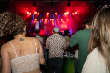 Dancing people and stage lights at the party.