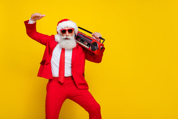 Photo of excited carefree aged man carry boombox enjoy music dance isolated on yellow color background