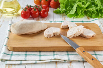 Boiled chicken filled with spices and herbs on a wooden table.