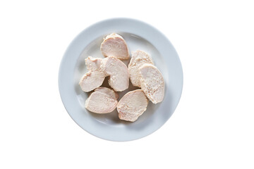 Pieces of boiled chicken breast in a ceramic plate isolated on white background. Top view.