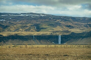 waterfalls in Iceland with mountains on the background