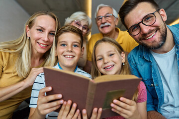 child family portrait woman mother man father grandmother daughter group reading book education...