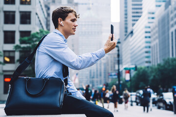  young proud ceo in earbuds using bluetooth for calling