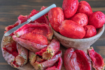 Peeled prickly pear on wooden background.