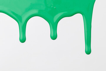 Acrylic paint blot, chaotic brushstroke, spot flowing on white paper background. Creative green color backdrop, fluid art.