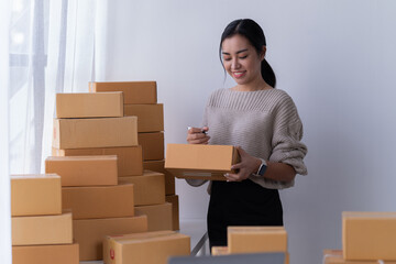 startup girl Small SME business owners work with laptop computers at work. with parcel paper boxes for delivery to customers online selling, Ecommerce,