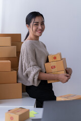 startup girl Small SME business owners work with laptop computers at work. with parcel paper boxes for delivery to customers online selling, Ecommerce,