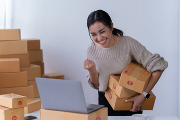 startup girl Small SME business owners work with laptop computers at work. with parcel paper boxes for delivery to customers online selling, Ecommerce,