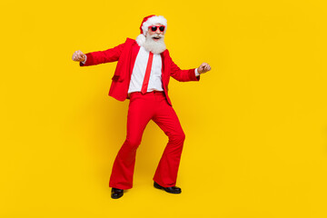 Fototapeta na wymiar Full length photo of positive funky retired guy wear red tux claus hat having fun empty space isolated yellow color background