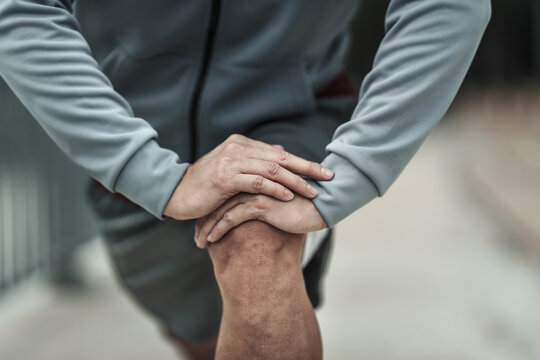 A Man Stretching His Muscle  In The City Center Park Before  Cardio Workout, Running.  Health And Lifestyle In Big City Life Concept.