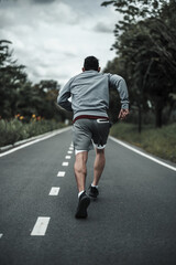 A man  jogging in the city center park cardio workout, running.  Health and Lifestyle in big city...