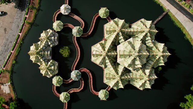 Beautiful buddhist temple in a town near Bangkok, Thailand. Aerial drone footage, top down view. 