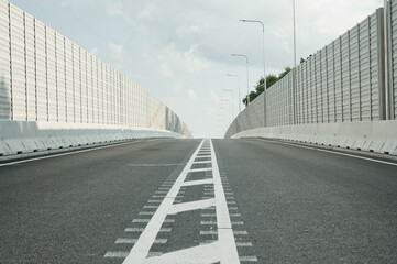 new asphalt road close-up in the background sky and clouds
