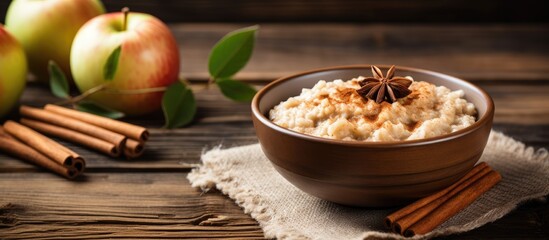 Obraz na płótnie Canvas Delicious apple cinnamon porridge Natural breakfast on wooden table With copyspace for text