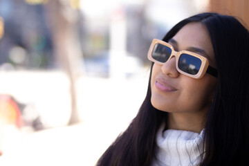 Native American young woman looks away. Sunglasses concept. Sunny day.