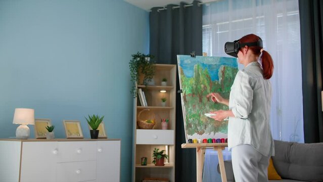 modern art, young woman uses modern technology and draws a picture wearing vair glasses while standing in room