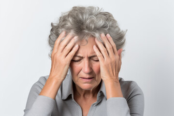 Older woman feling stressed out with a migraine headache isolated on a white background