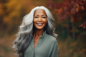 Naklejka premium Generative AI image of happy beautiful woman walking in the park blurred forest and orange dry leaves background