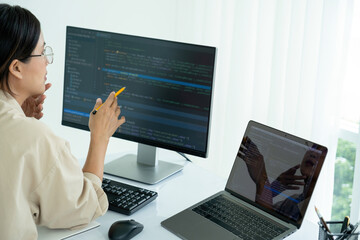 Female IT programmer innovates at office desk.