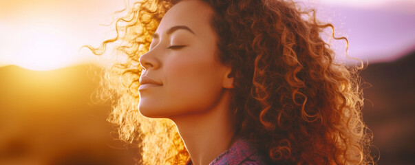 Close up sunset portrait of attractive woman with closed eyes and sun in back light, Dreaming and enjoying feeling concept lifestyle emotion, Serene female people outdoor with curly hair - obrazy, fototapety, plakaty