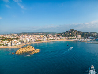 Fototapeta premium Blanes from the air on the Costa Brava of Girona. paradisiacal main beach with transparent turquoise blue water