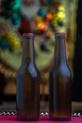 Cold beer bottles on wooden table with selective focus