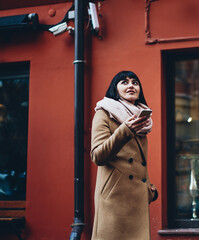 Charming female using phone in street