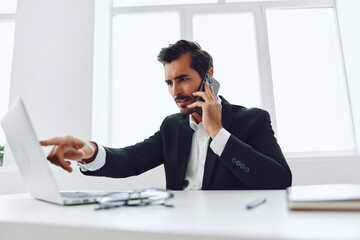 Fototapeta premium Businessman man smile conversation winner computer phone suit talk caucasian happy technology laptop office