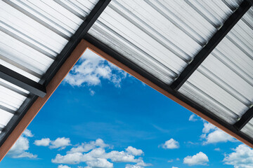 Metal sheet, aluminum roof structure against blue sky on daylight well space for text - obrazy, fototapety, plakaty