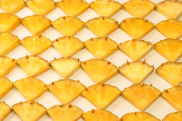 Pineapple juicy yellow slices on a white background.