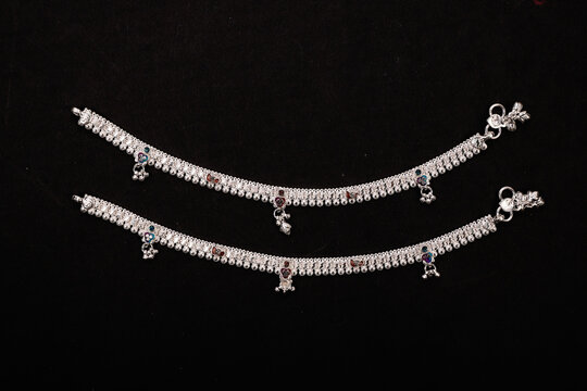 Indian Silver Anklets Jewellery Isolated On Black Background.