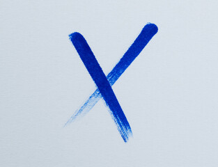 A blue cross on the paper
