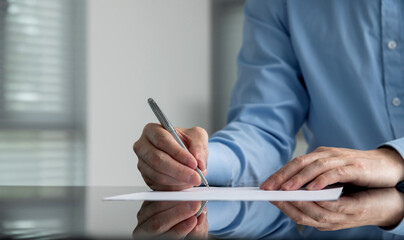 Businessman hand writing on paper