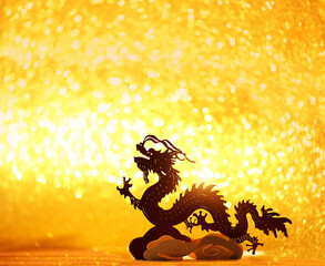 asian dragon decor close up on light golden shiny abstract glittering background. lunar new year...