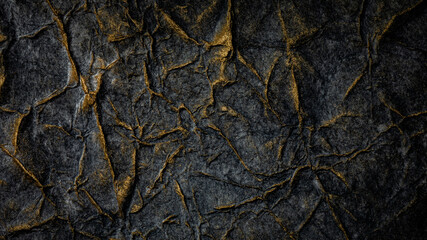 Black texture with golden paint. Rough black and gold background