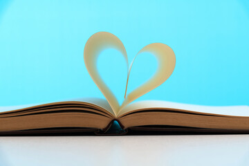 Book pages curved into heart shape