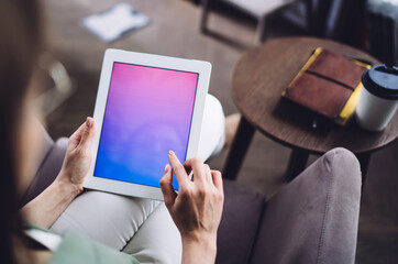 Faceless female using tablet with gradient screen